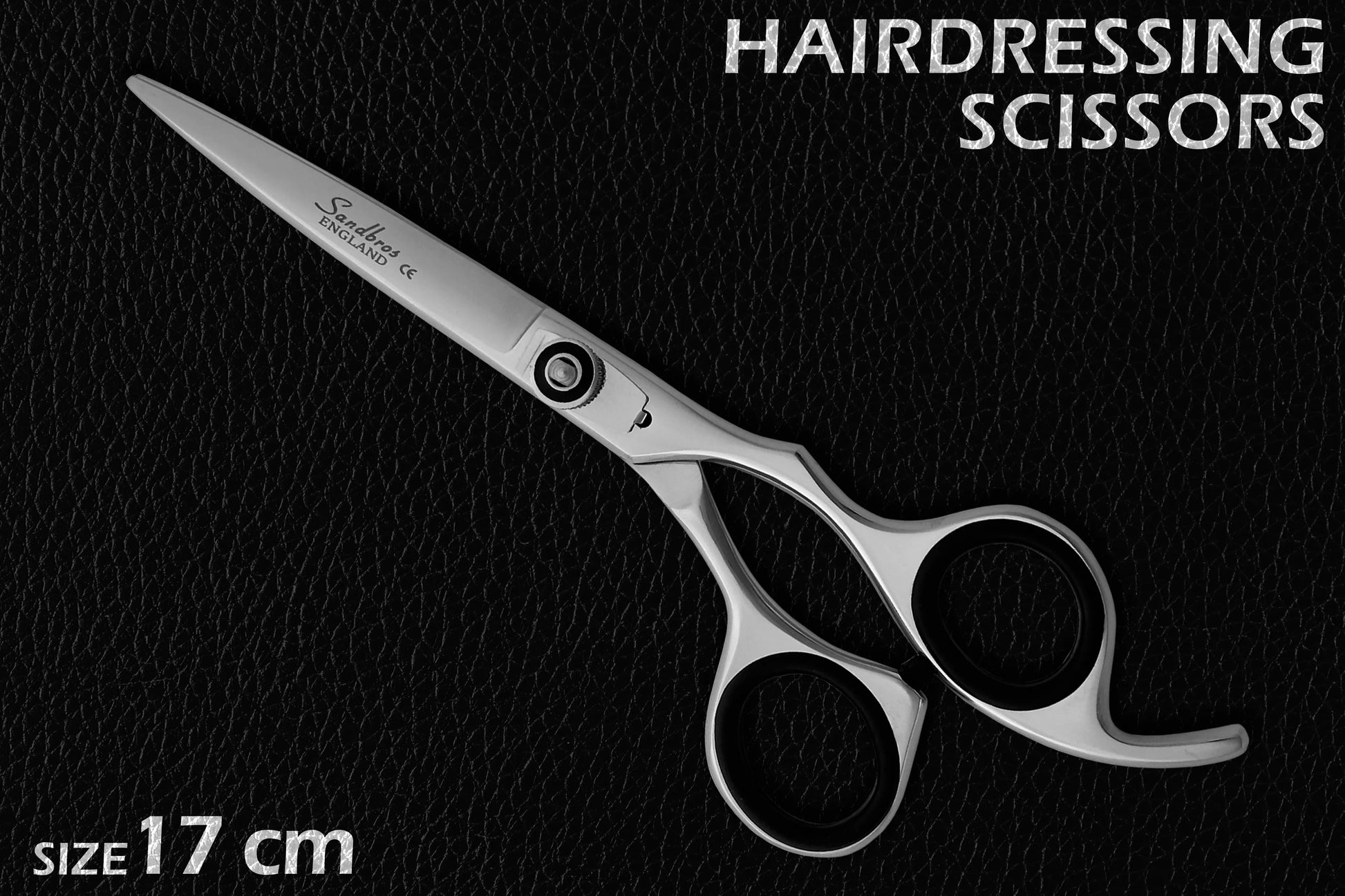 hair scissors on leather black background