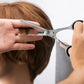 barber cutting thinning hair of a boy with hair thinning scissors