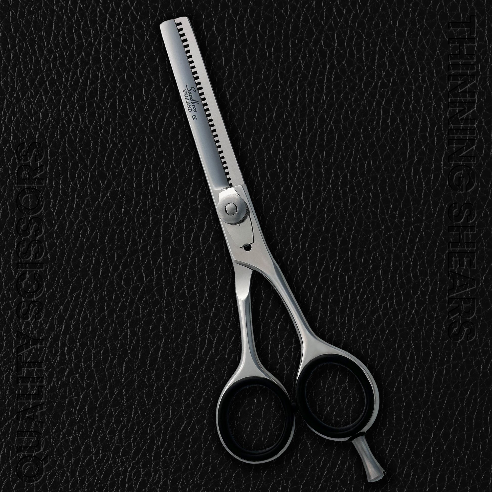 premium hair thinning scissors on a black leather background